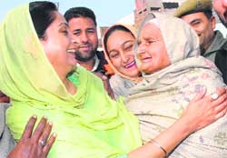 Harsimrat Kaur, wife of SAD chief Sukhbir Singh Badal, is greeted by women during a mass contact programme in Bathinda