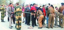 BSF jawans frisk the visitors at Attari joint checkpost as part of security measures