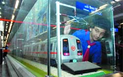 A schoolgirl looks at the model of a Metro train at the Metro Museum, Patel Chowk metro station in New Delhi