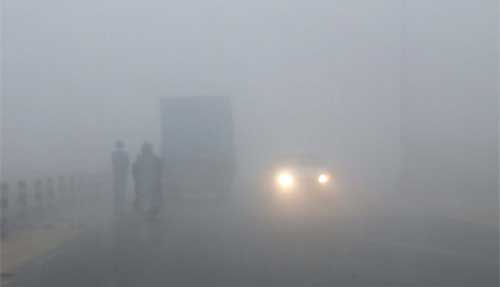 Vehicles moved at a very slow speed on the Express Highway near Gurgaon on Tuesday morning because of dense fog