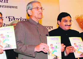 Governor BL Joshi releases a souvenir at the International Hindi Conference in Dehradun