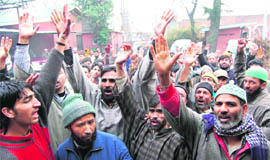 NC supporters raise slogans in support of Omar Abdullah after he was declared the Chief Minister in Srinagar on Tuesday.