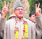 NC patron Farooq Abdullah shows victory sign after his son Omar Abdullah announced in New Delhi that he would head the NC-Congress coalition government in Srinagar on Tuesday.