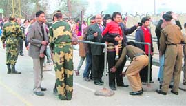 BSF jawans frisk visitors at the Attari-Wagah joint check post in Amritsar district on Monday.