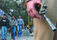 A CRPF jawan keeps a vigil at CP in view of the New Year celebrations in New Delhi on Wednesday.