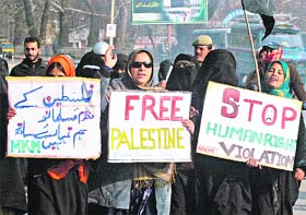 Activists of the Muslim Khawateen Markaz hold a protest against the Israeli bombings in Gaza, in Srinagar