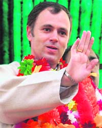 NC president Omar Abdullah waves to party supporters while addressing them in Srinagar