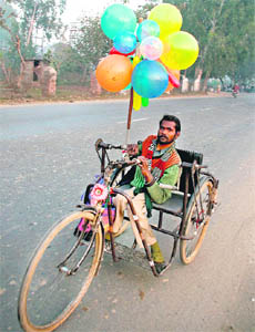 A physically challenged person sells balloons in Jammu.