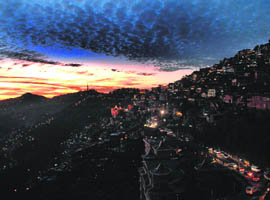 A view of clouds hovering over Shimla at the time of dusk.