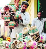 A vendor sells kangris in a busy market in Jammu. 