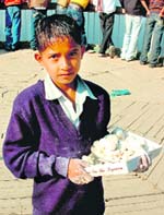 Mohinder sells balls made of wheat flour at Mansar lake in Jammu.