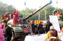 Kids and locals enjoying the tank ride during the hi-tech Army arms and weapon display in Ferozepur on Saturday. 