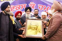 Surjeet Singh Barnala, governer of Tamil Nadu, being presented his portrait by the management of a private school during its annual funcion in Bathinda 