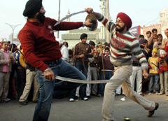 Sikh men play Gataka during a nagar kirtan on the eve of Gurpurb in Gurgaon on Saturday.