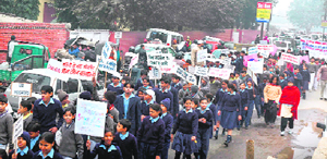 Students of RMS Senior Secondary School take part in a road safety march organised by the traffic police in Gurgaon on Saturday.