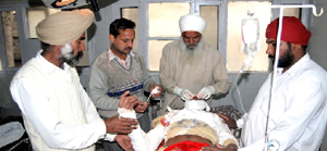 An injured person being treated at a hospital in Mansa on Sunday after the roof of the well collapsed during a Nagar Kirtan.