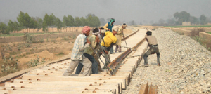 Workers laying the track for the Abohar-Fazilka rail link near the Abohar-Malout road bypass.