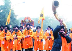Panch Piyaras with a decorated palki of Sri Guru Granth Sahib during a nagar kirtan held on the occasion of the birth anniversary of the Guru, in New Delhi