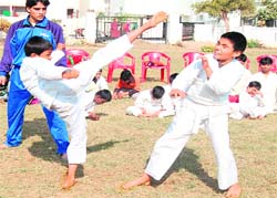 Players in action at the district-level Karate Championship in Haridwar on Sunday. 
