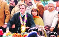 Chief Minister-designate Omar Abdullah arrives in Jammu to a rousing reception by NC supporters on Sunday.