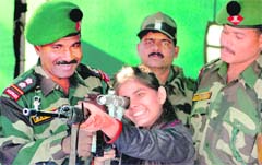 A girl takes the aim during a two-day Army exhibition at Satwari in Jammu