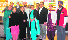 The Hundal family with the Grewals outside the store from where the winning ticket of Mega Million lottery in the US was sold.