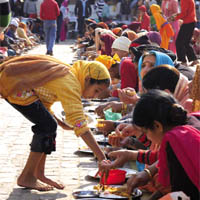 A girl serves langar to devotees at a gurdwara in Model Town, Jalandhar, on Monday.