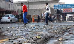 The road outside railway station in Bathinda was in a mess on Tuesday as waste was dumped after the cleaning of a sewer