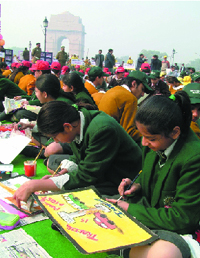School students participate in a drawing competition at India Gate in New Delhi on Tuesday.
