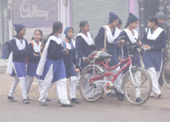 Girls go to school in foggy weather on Tuesday morning in Gurgaon.