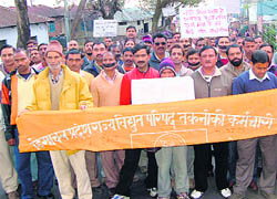 Employees of the electricity board marching in protest against the death of the lineman working in the HPSEB, Dharamsala, on Tuesday.