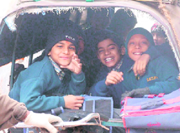 Children enjoy themselves while going to school in foggy weather on Tuesday morning on the Khandsa road in Gurgaon.