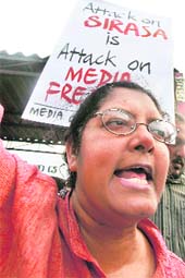 A media rights group supporter shouts slogans against the attack on the MTV/MBC transmission station in Colombo on Tuesday. Masked gunmen threw grenades and destroyed the main studio of Sri Lanka's largest private broadcaster on Tuesday.