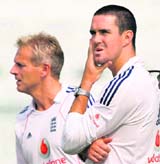 In this file photo England captain Kevin Pietersen is seen with coach Peter Moores during a practice session at Kanpur on November 20, 2008.
