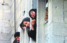 Palestinian relatives from the Deeb family on Wednesday mourn during the funeral of 10 of their family members who were killed in an Israeli strike on a UN school in Gaza. Israeli forces blazed into towns on Tuesday striking Hamas targets and also hitting three UN-run schools. 
