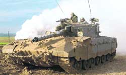 Israeli soldiers atop a tank outside the northern Gaza Strip
