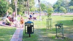 People bask in the sun at Galiara park around Golden Temple in Amritsar.