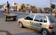 A horse cart pulls a car that ran out of fuel in Bathinda