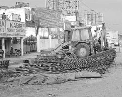 Shopkeepers use roadside to dump construction material along the Zirakpur-Patiala highway.