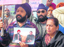 Parents of Capt Chawla and Uttarakhand Sikh Federation members stage a protest in Dehradun on Friday.