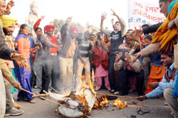 Protesting members of the EGS Teachers' Union burning an effigy of chief minister Parkash Singh Badal in Bathinda