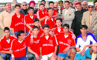 The Doon Hawk team with the District Hockey League trophy in Dehradun on Sunday.
