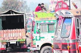 Drivers while away time playing cards in Jammus Industrial Area as the truckers strike enters the seventh day on Sunday. 