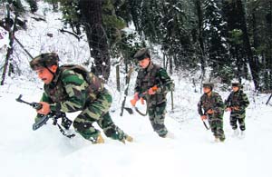 Troops patrol the snow-clad Line of Control (LoC) at Uri in Baramulla district on Sunday. 