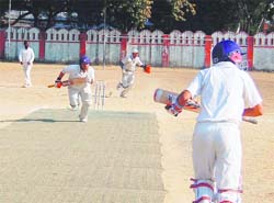 Batsmen steal a run at the 57th District Cricket League at the Survey Stadium in Dehradun