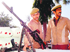 Policemen display weapons recovered in Jammu on Monday.