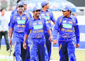 Sri Lankan cricketers leave the field following the tri-series ODI match against Zimbabwe