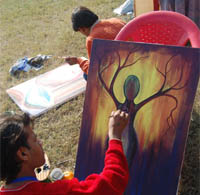 An artist busy giving final touches to his painting.