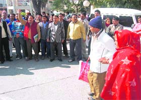 Employees attached with the health department raise slogans at Doon Hospital