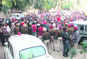 Activists of the Poorvanchal Sangharsh Morcha protest against a police official in Ludhiana on Tuesday.